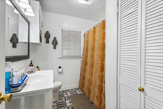 spare room featuring ornamental molding, dark wood-type flooring, ceiling fan, and a textured ceiling