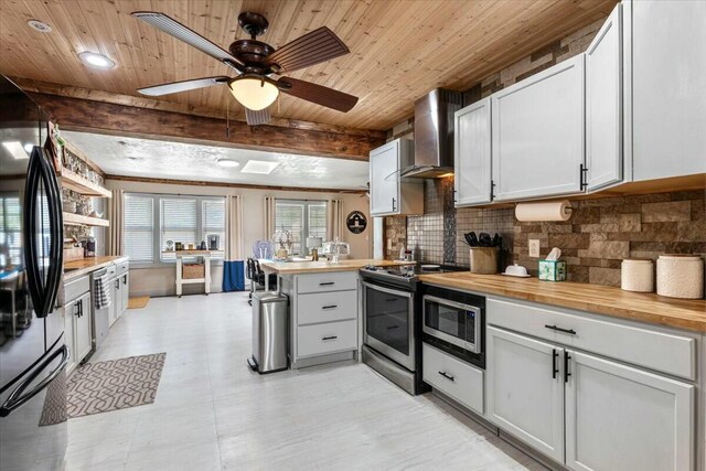 unfurnished living room with ceiling fan, crown molding, a skylight, and a textured ceiling