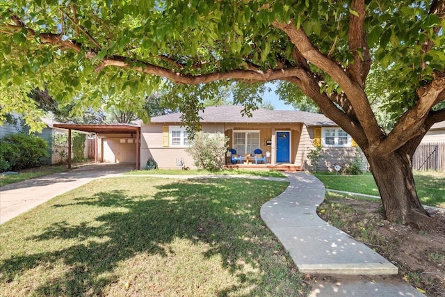 ranch-style house with a front yard, a carport, and a porch