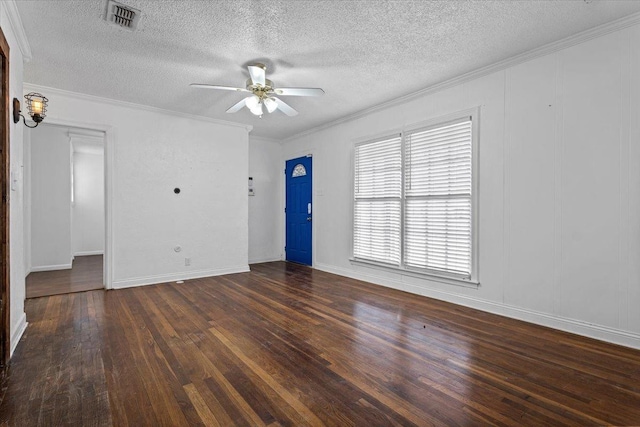 empty room with crown molding, ceiling fan, dark hardwood / wood-style flooring, and a textured ceiling