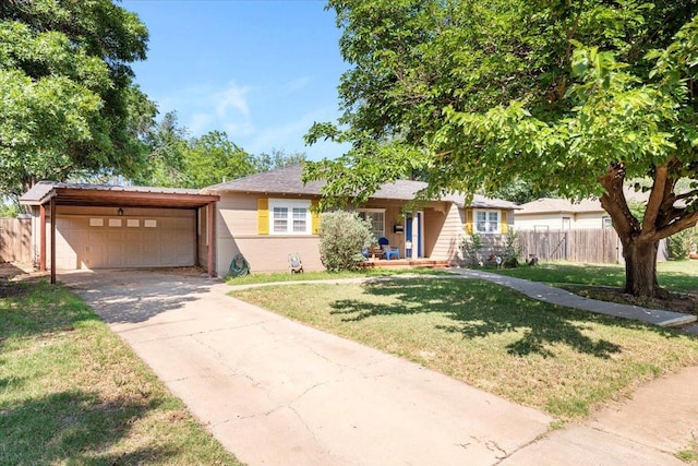 ranch-style home with a garage, a front lawn, and covered porch