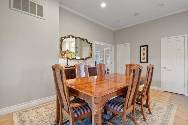 dining space with crown molding and light tile patterned floors