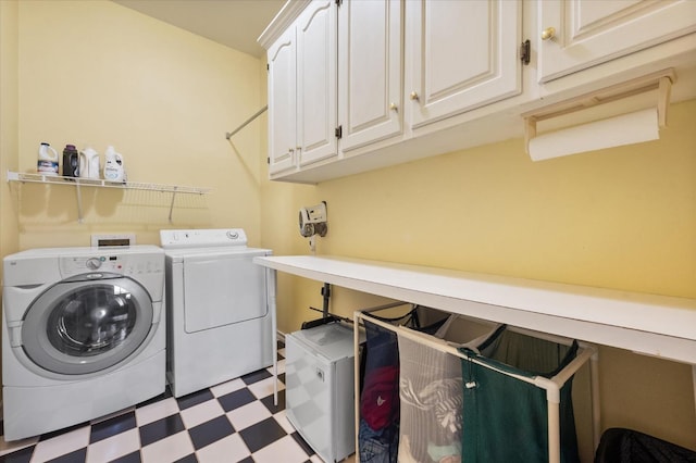 laundry room with independent washer and dryer and cabinets