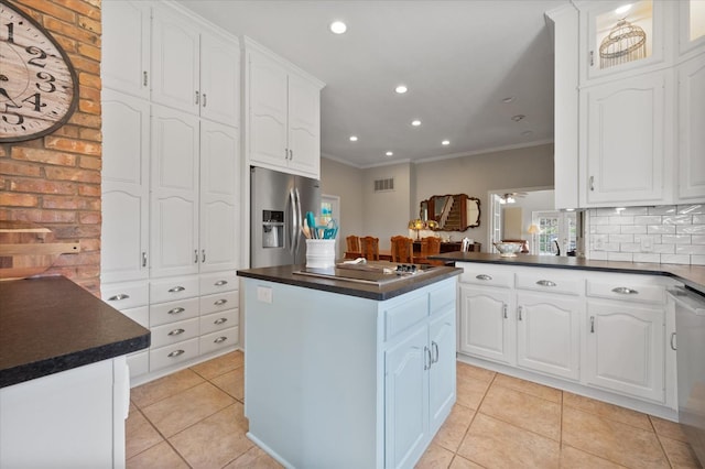 kitchen with white cabinetry, a center island, light tile patterned floors, kitchen peninsula, and stainless steel appliances