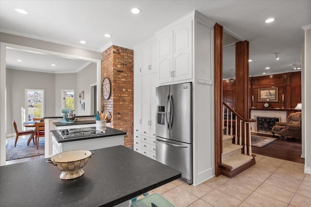 kitchen with white cabinetry, stainless steel fridge with ice dispenser, crown molding, and light tile patterned flooring