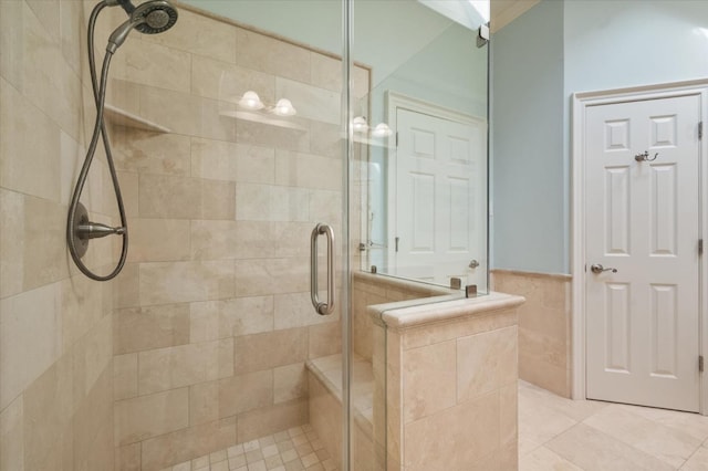 bathroom with tile walls and a shower with shower door