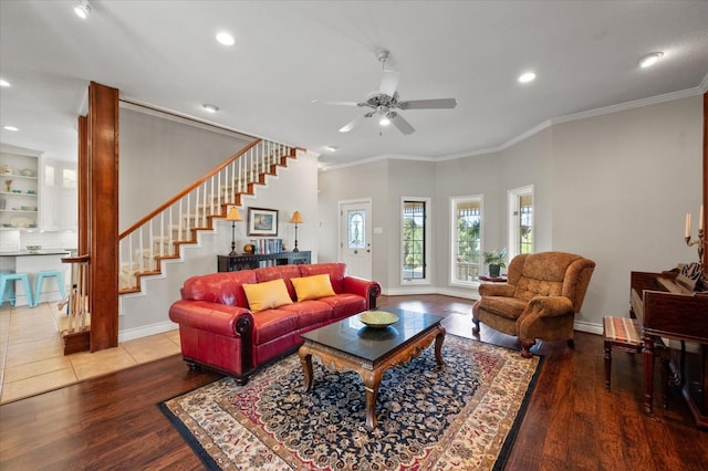 living room with crown molding, wood-type flooring, and ceiling fan