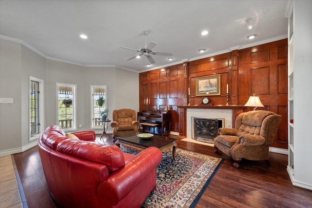 living room with crown molding, dark hardwood / wood-style floors, and ceiling fan