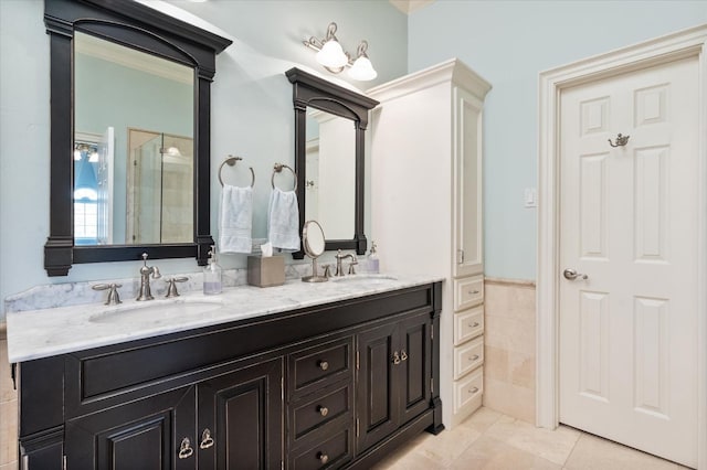 bathroom featuring tile patterned flooring, vanity, tile walls, and a shower with shower door