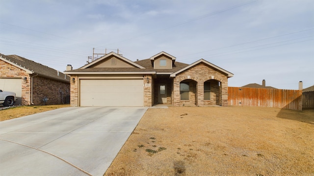 single story home featuring a garage, concrete driveway, brick siding, and fence