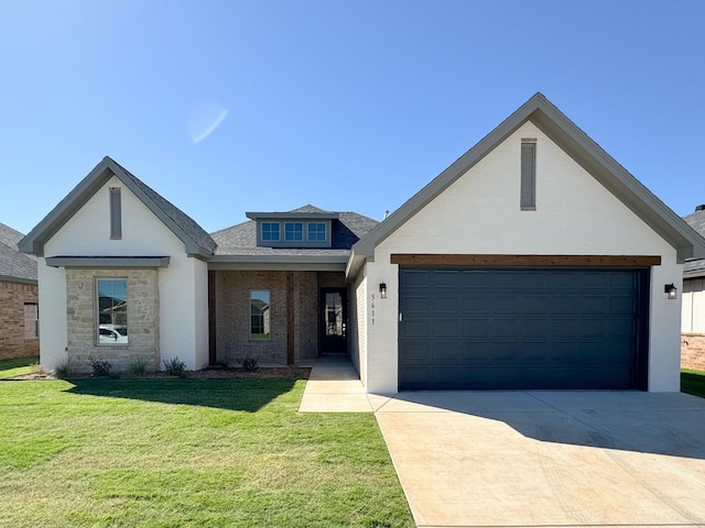 view of front of house featuring a garage and a front yard