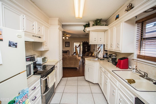5008 59th St, Lubbock, TX 79414 - kitchen featuring white appliances, under cabinet range hood, light tile patterned flooring, light countertops, and a ceiling fan