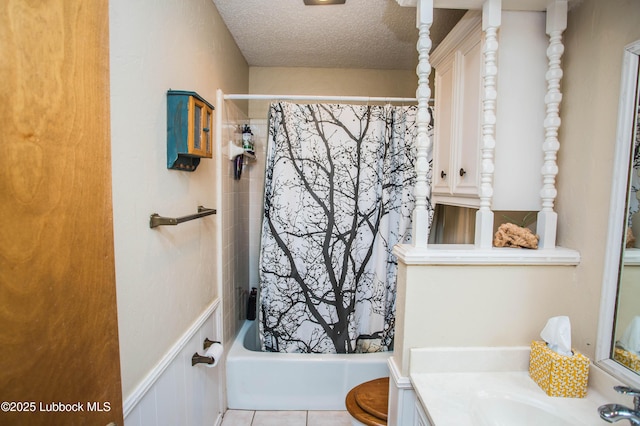 5008 59th St, Lubbock, TX 79414 - bathroom featuring vanity, shower / bath combo with shower curtain, a textured ceiling, and tile patterned floors