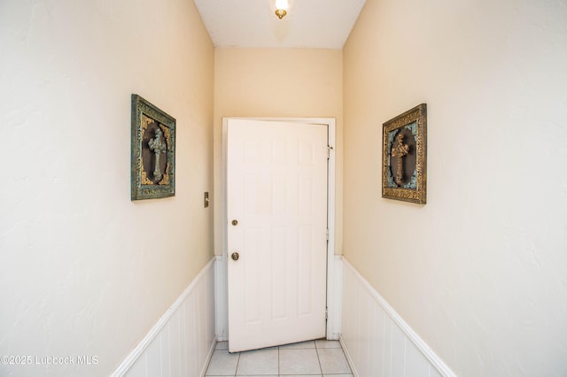 5008 59th St, Lubbock, TX 79414 - doorway to outside featuring wainscoting, a decorative wall, and light tile patterned floors