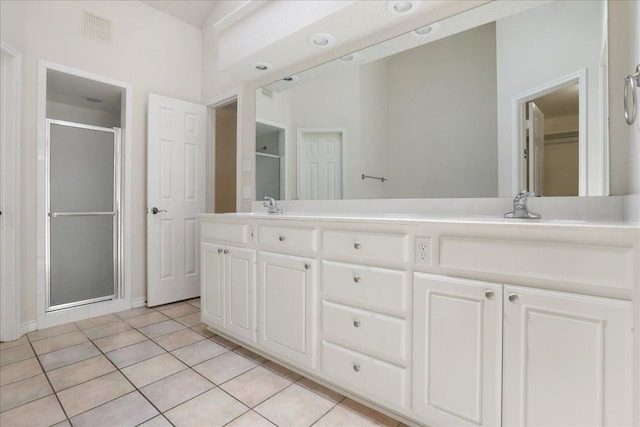 bathroom featuring tile patterned flooring, vanity, and a shower with shower door