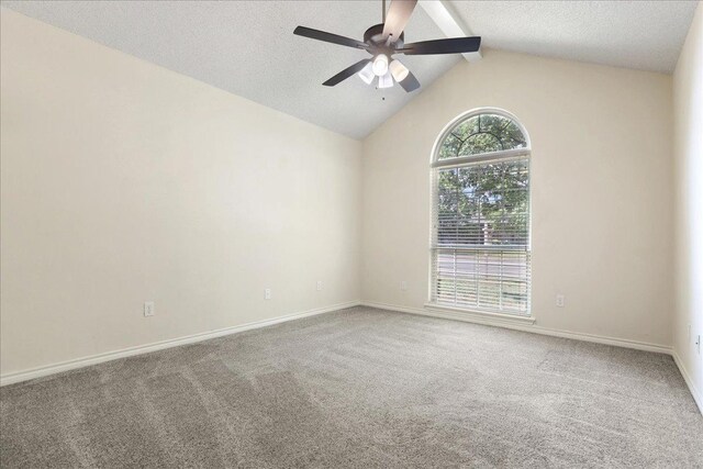 spare room with lofted ceiling with beams, carpet, and a textured ceiling