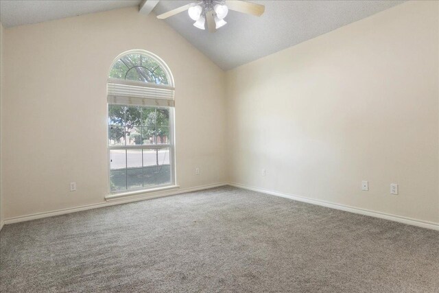 carpeted empty room with lofted ceiling with beams and ceiling fan