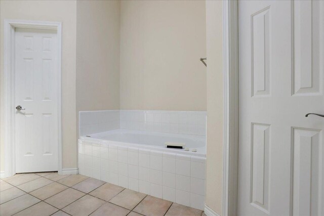 bathroom featuring tile patterned floors and tiled bath