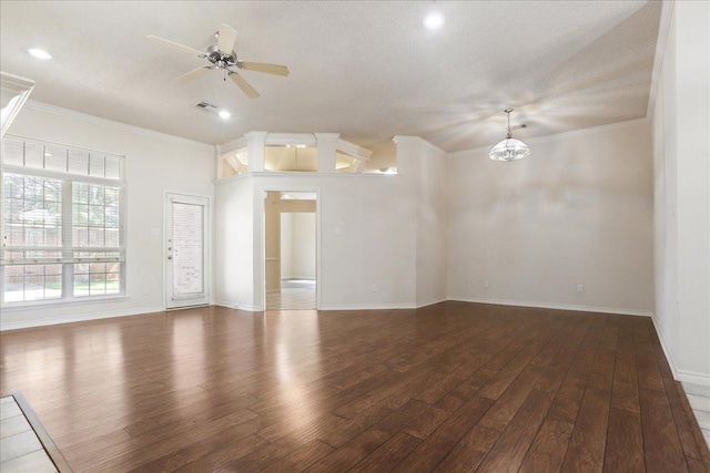 spare room with ornamental molding, dark hardwood / wood-style floors, ceiling fan with notable chandelier, and a textured ceiling