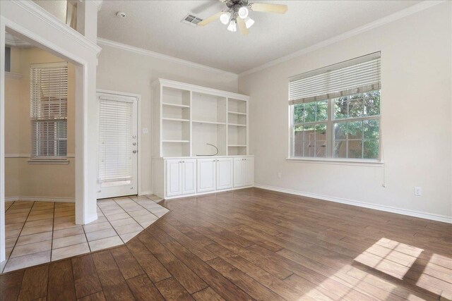 interior space featuring crown molding, ceiling fan, and light wood-type flooring