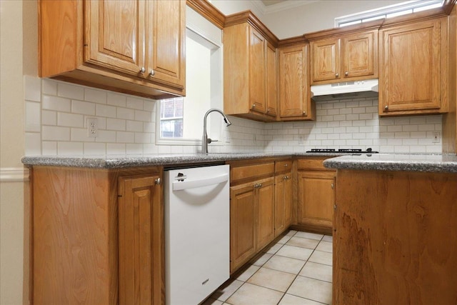 kitchen with gas stovetop, dishwasher, light tile patterned flooring, and backsplash