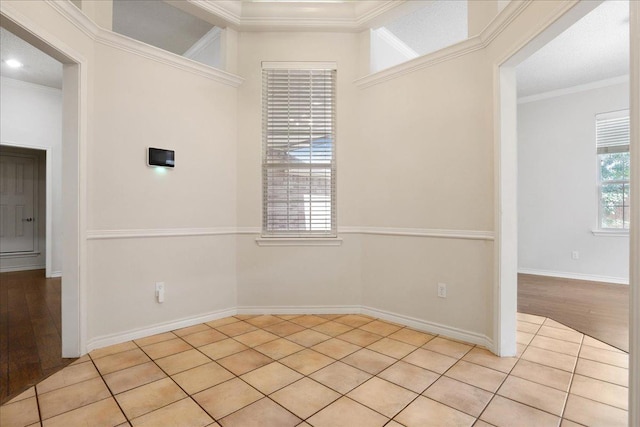 unfurnished room with ornamental molding and light tile patterned floors