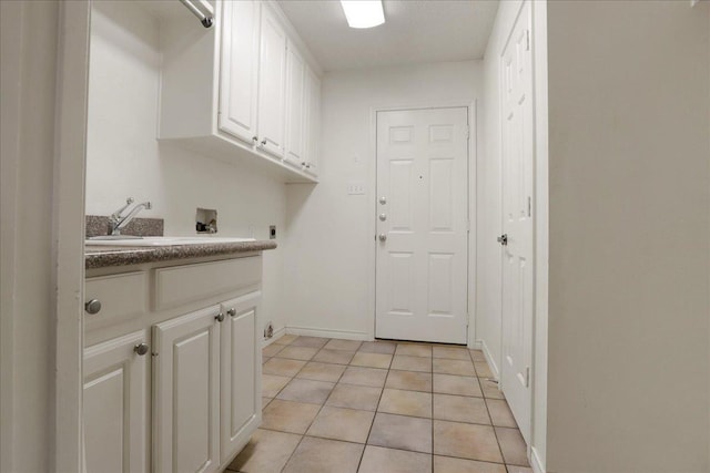 laundry area with sink, cabinets, light tile patterned floors, hookup for a washing machine, and electric dryer hookup