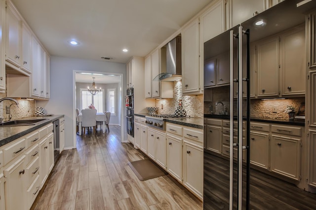 5419 87th St, Lubbock, TX 79424 - kitchen with wall chimney range hood, dark countertops, appliances with stainless steel finishes, tasteful backsplash, and recessed lighting