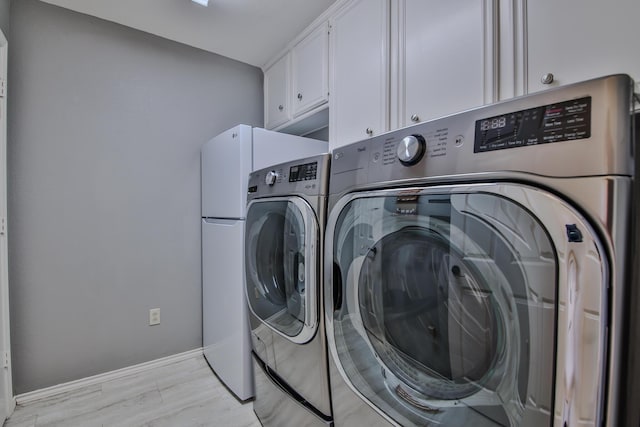 5419 87th St, Lubbock, TX 79424 - laundry area with washer and dryer and cabinet space