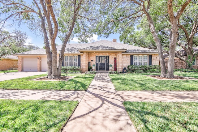 5419 87th St, Lubbock, TX 79424 - ranch-style home featuring brick siding, an attached garage, concrete driveway, a front yard, and a chimney
