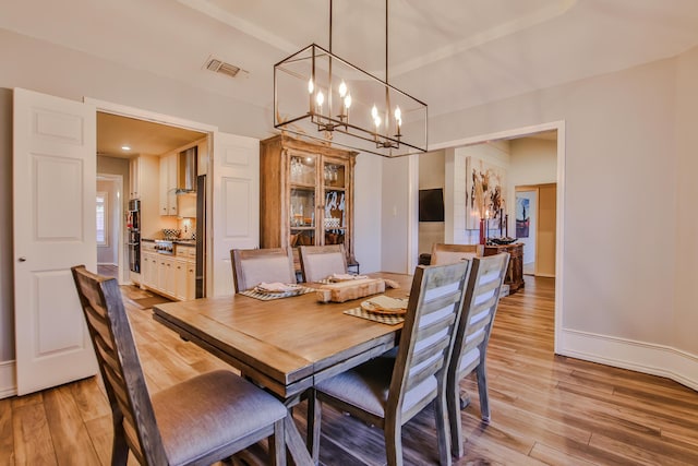 5419 87th St, Lubbock, TX 79424 - dining space featuring a chandelier and light wood-style flooring