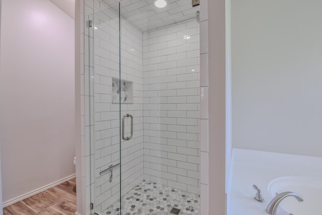 5419 87th St, Lubbock, TX 79424 - full bath featuring a stall shower, a bath, and wood finished floors