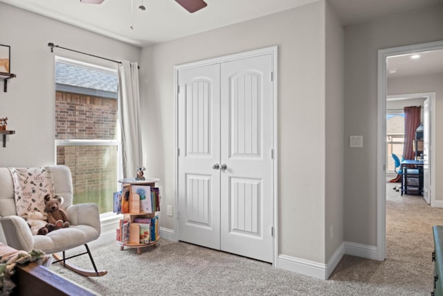 sitting room with ceiling fan and carpet floors