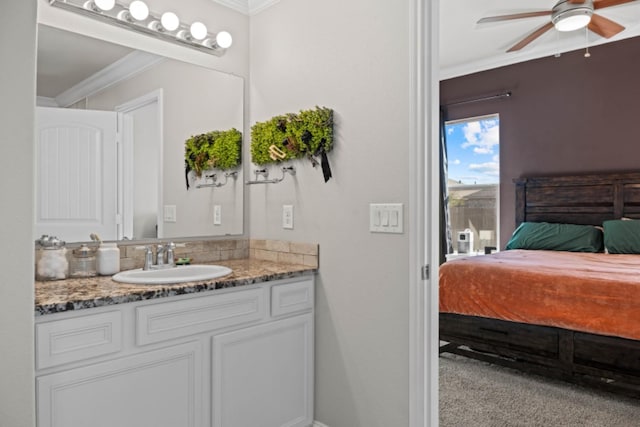 bathroom featuring vanity, ornamental molding, and ceiling fan