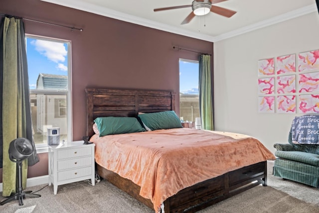 carpeted bedroom with ornamental molding and ceiling fan