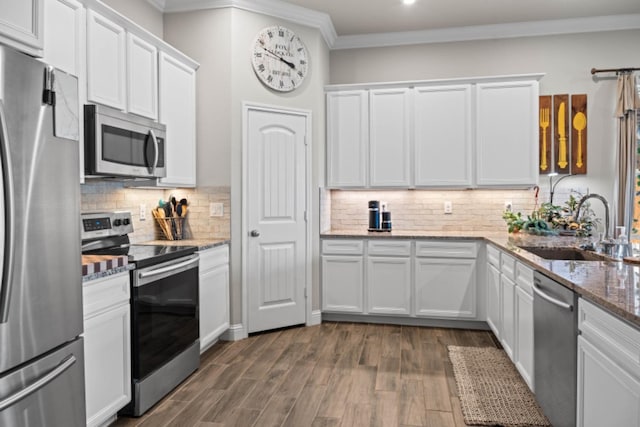 kitchen with white cabinetry, light stone countertops, and appliances with stainless steel finishes