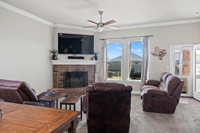 living room with ceiling fan, ornamental molding, a fireplace, and light carpet