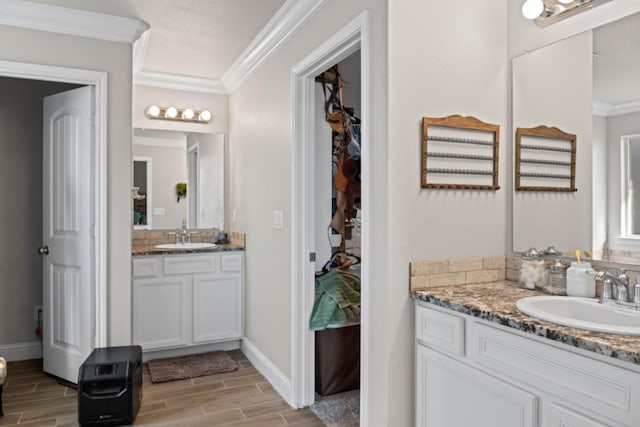 bathroom with crown molding and vanity