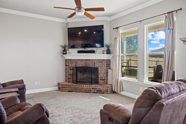 living room with crown molding, a brick fireplace, carpet, and ceiling fan