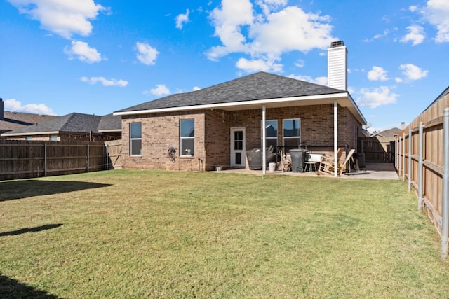 back of house featuring a yard and a patio area