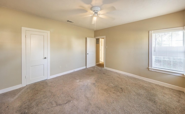 carpeted spare room with ceiling fan