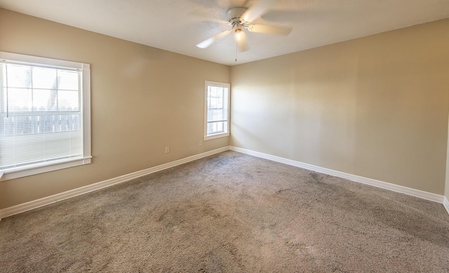 carpeted spare room with ceiling fan