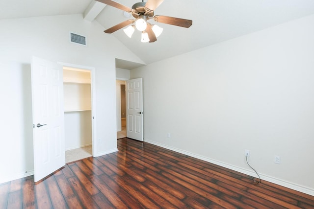 unfurnished bedroom featuring ceiling fan, dark hardwood / wood-style floors, and vaulted ceiling with beams