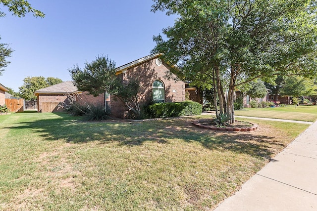 obstructed view of property with a front lawn