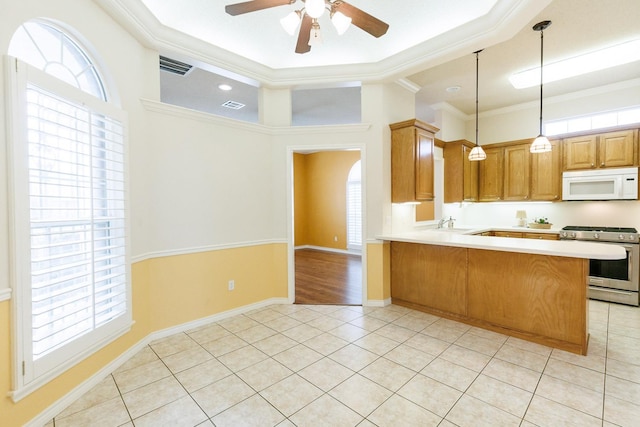 kitchen with ornamental molding, light tile patterned flooring, stainless steel gas range, and kitchen peninsula