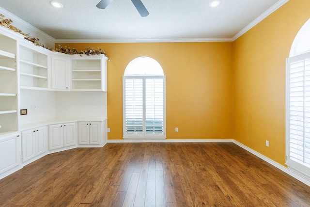 empty room featuring ornamental molding, dark hardwood / wood-style floors, and ceiling fan