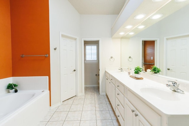 bathroom featuring tile patterned flooring, vanity, and a tub to relax in