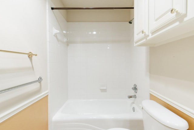 bathroom with tub / shower combination and toilet