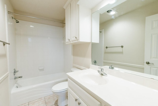 full bathroom featuring tile patterned flooring, vanity, tiled shower / bath, and toilet