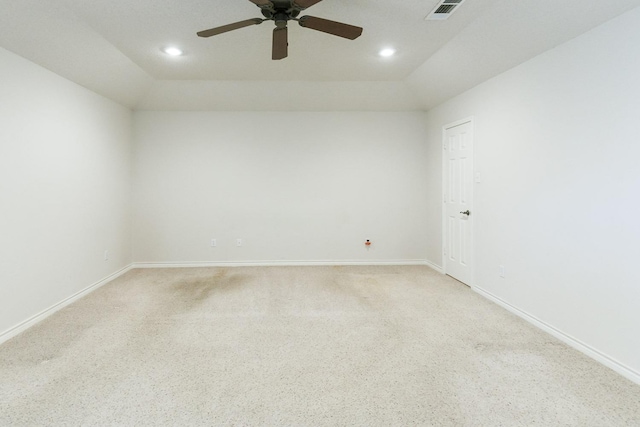 spare room with carpet floors, vaulted ceiling, and ceiling fan